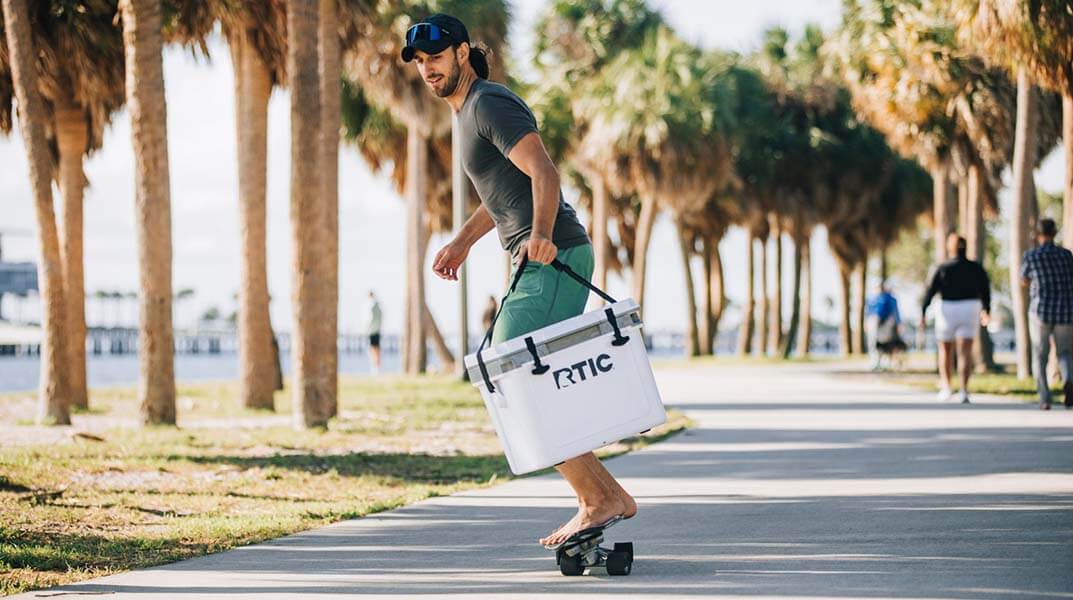 A man carrying the RTIC 22QT Ultra-Light cooler